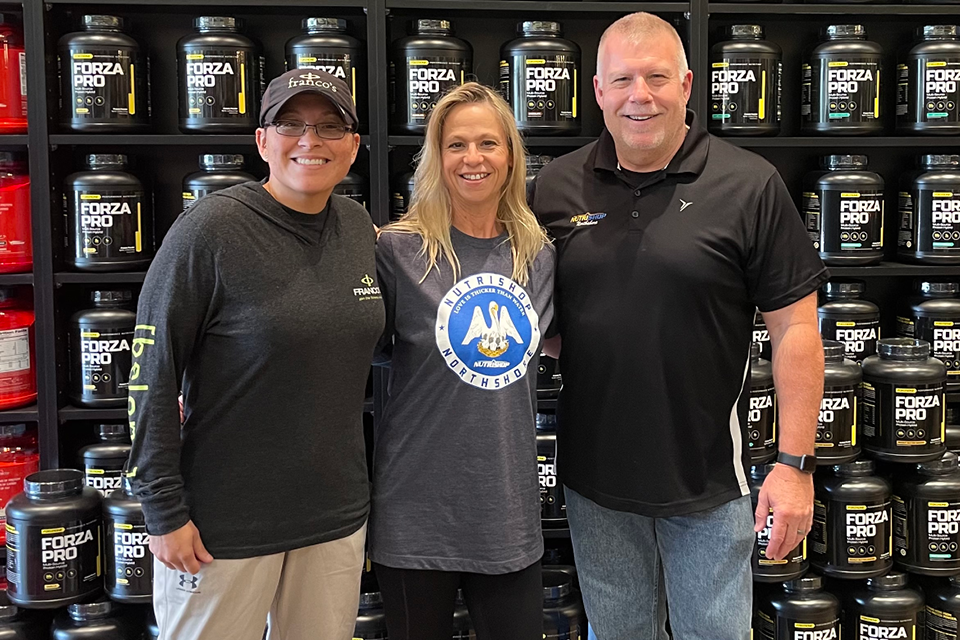 Amy Bernard with Alex Tanguis in Nutrishop Covington, Louisiana