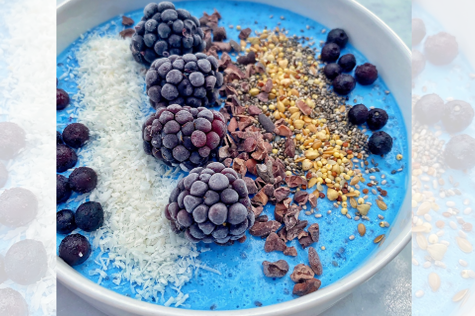 Blue smoothie bowl with berries and nuts