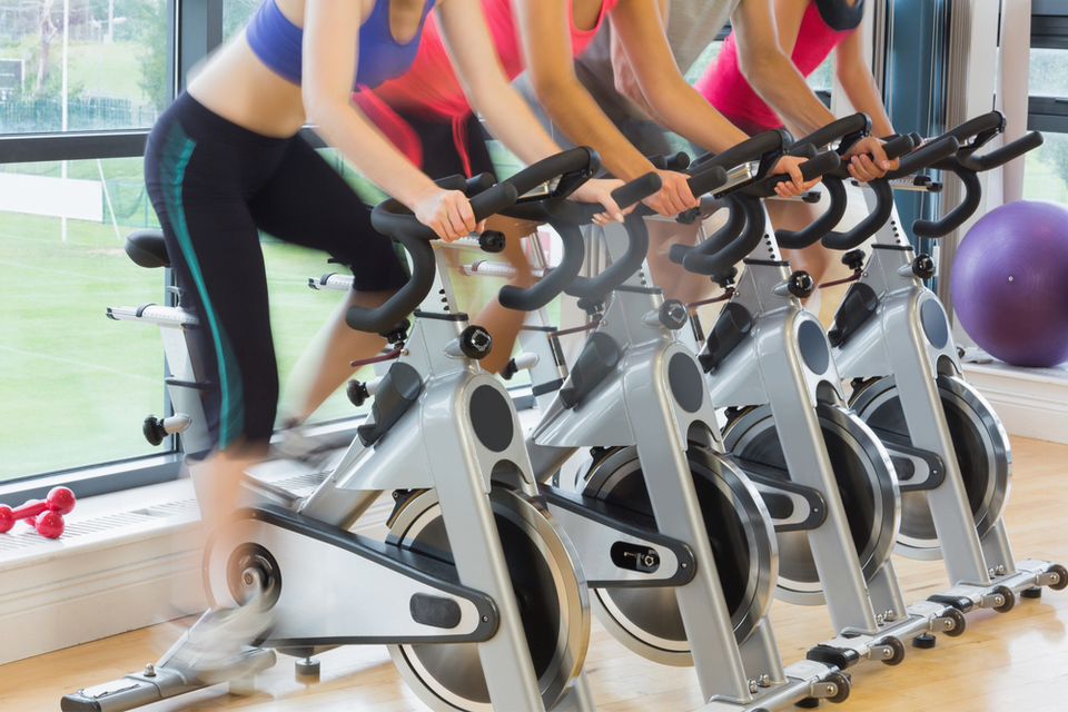 Group of people on cycle machines