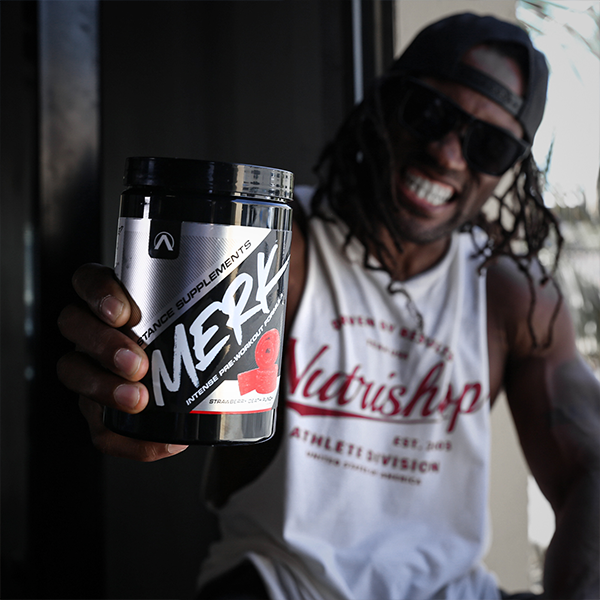 Man grinning with Merk supplement in his hand