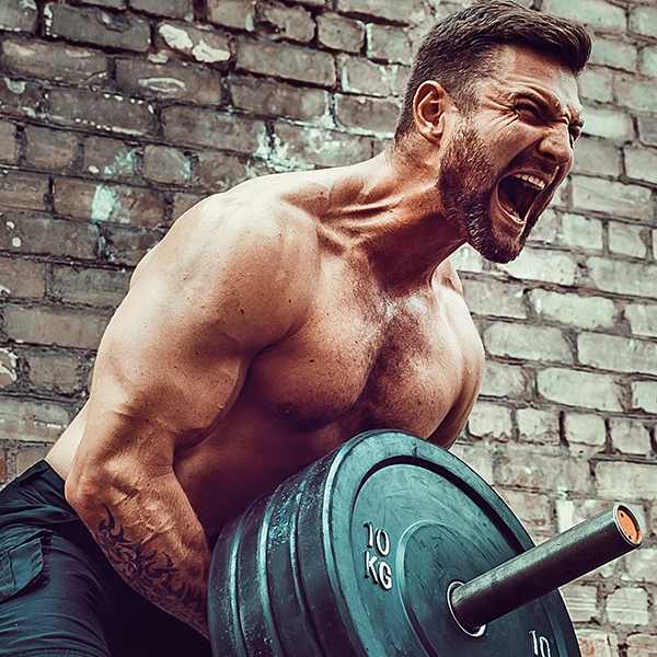 Man screaming as he lifts up a barbell