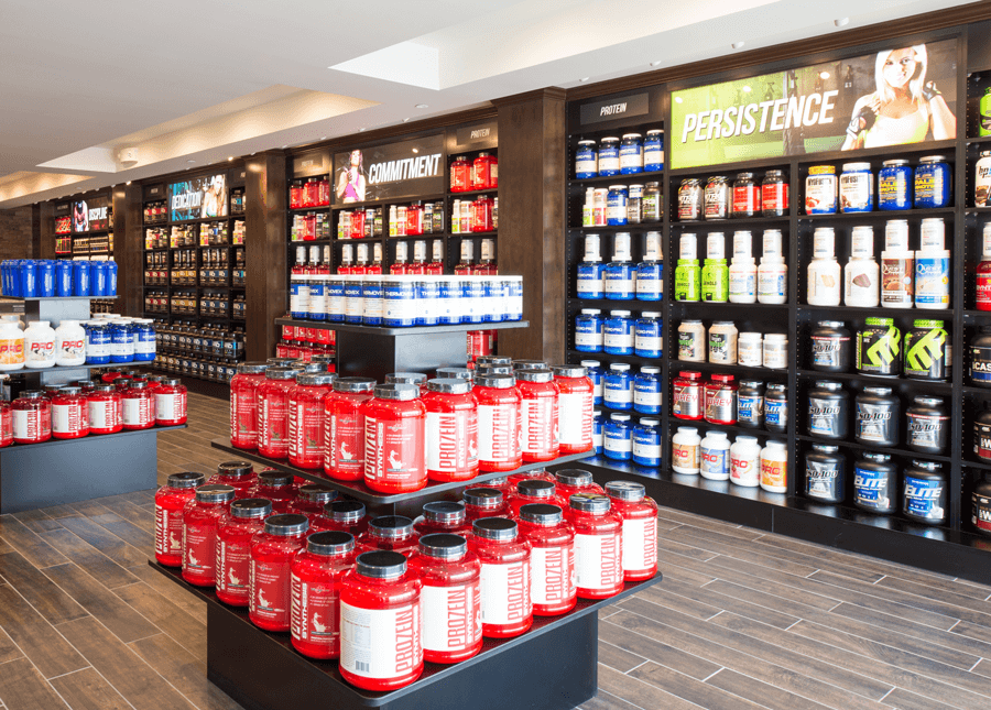 Inside of nutrishop store with center display filled with supplements