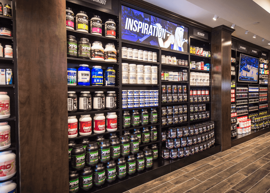 Inside of nutrishop store with wall filled with supplements