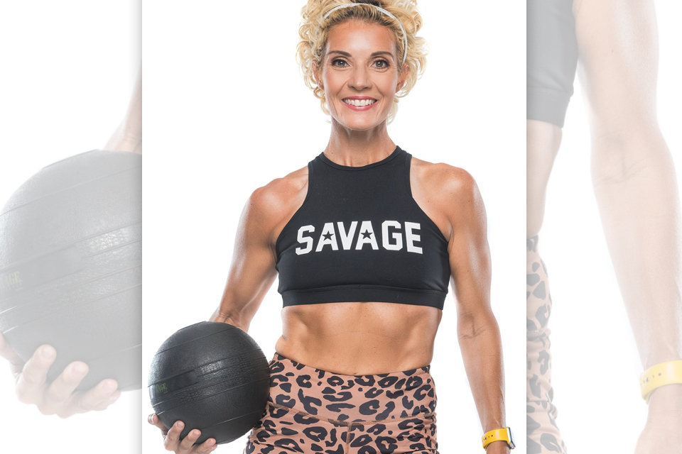 Personal trainer Kimberly Lynn posing with a medicine ball