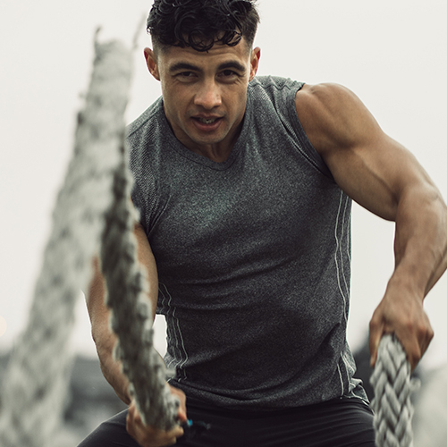 Man doing battle rope waves exercise