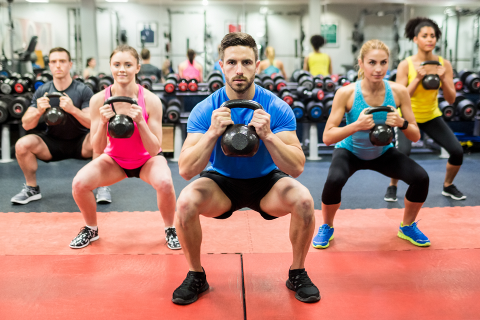 Image of men and women working out boot camp style