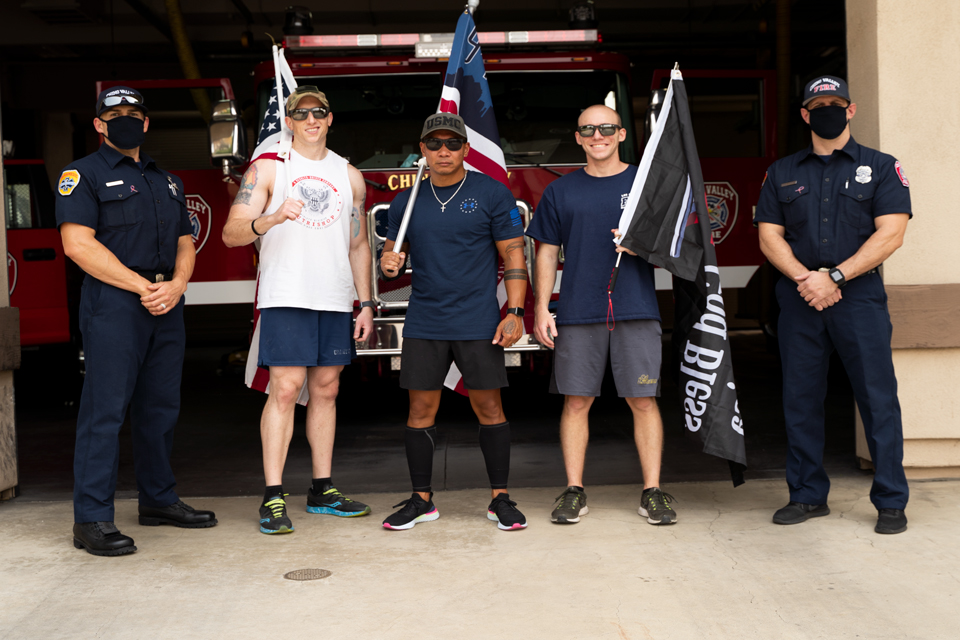 Jordan Houle (second from left) and Ray Salvante (third from left) pose with a young man who just got accepted into the L.A. County Fire Academy and two firefighters from Station 66. 