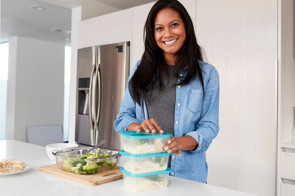 Woman meal prepping her lunches for the week. 