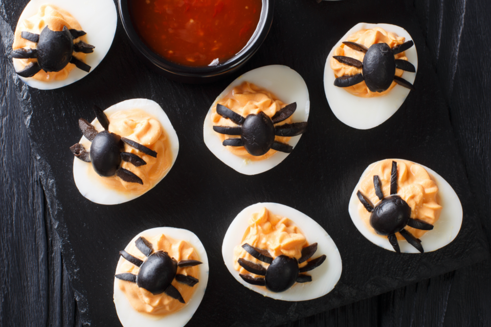 Sliced Olives decorated on deviled eggs to look like spiders