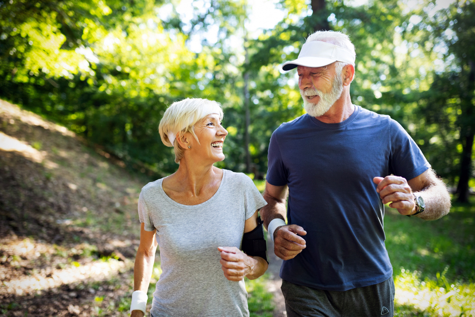 Older couple hiking through the woods