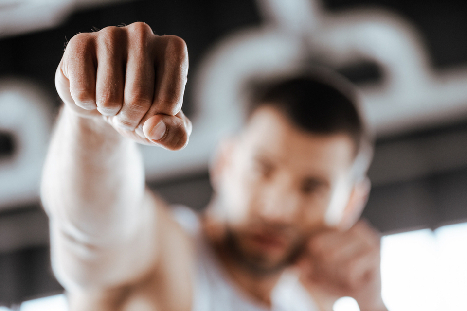 Close up of a man throwing a fist