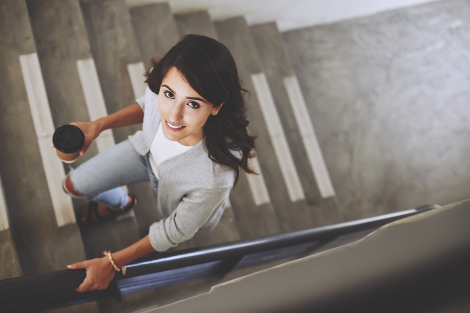 Overhead view of woman walking up stairs