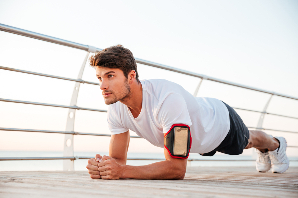 Man doing a plank on a bridge