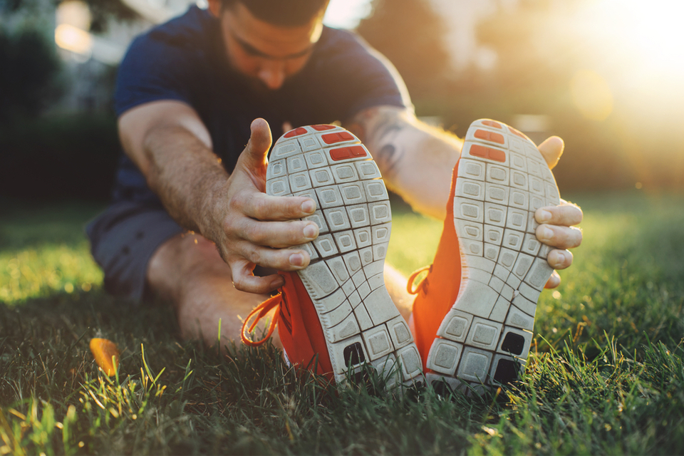 Man stretching in grass