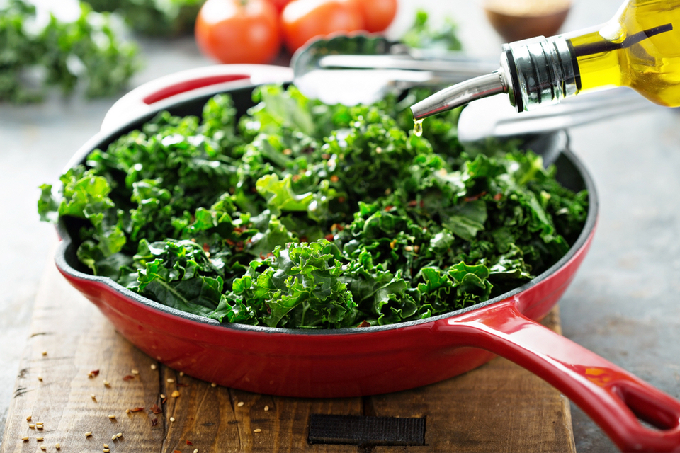 oil being applied to a salad