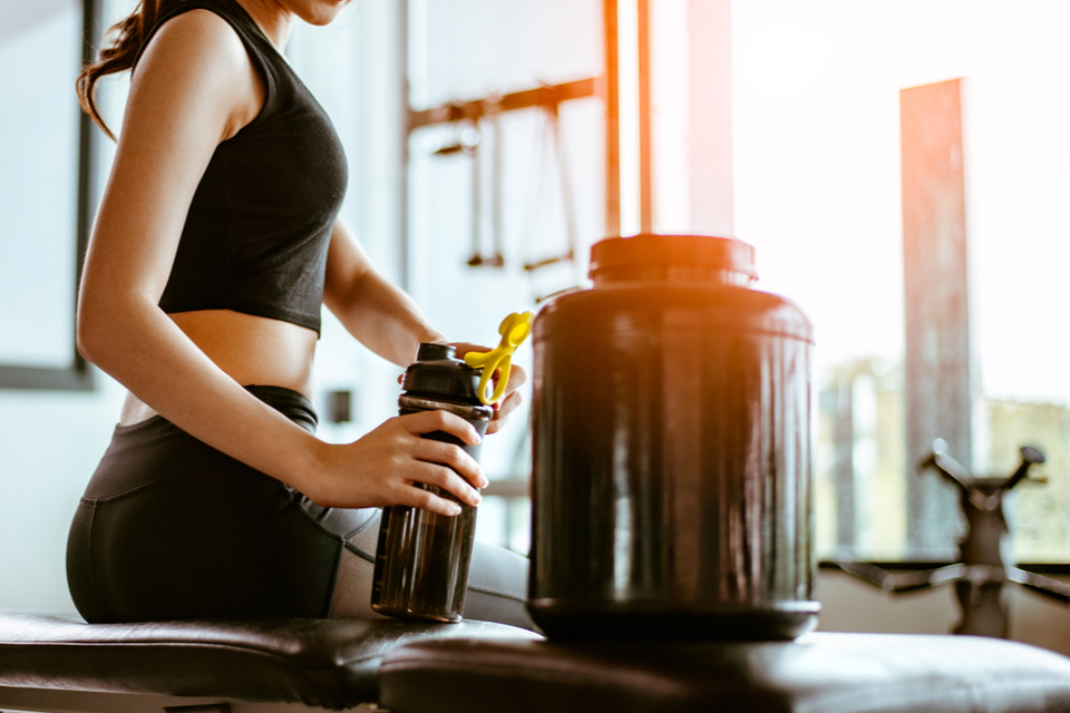 Woman serving a supplement into her bottle