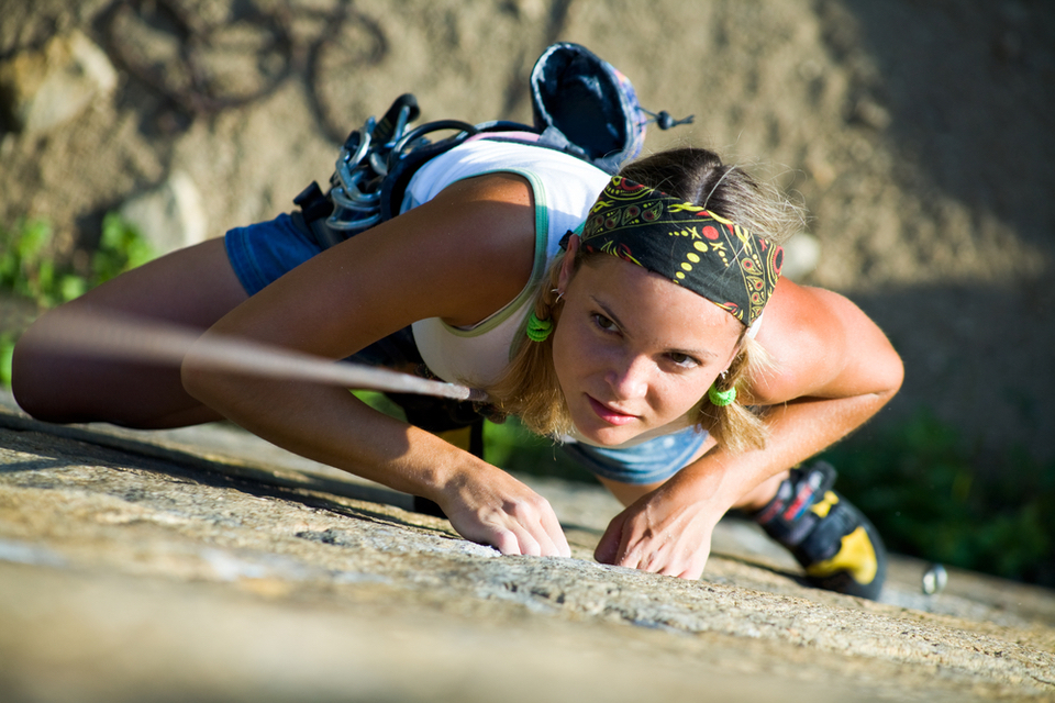 woman doing outdoor rock climbing