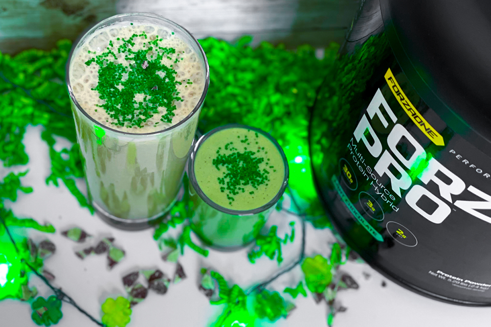 Protein shake with 4 leaf clovers around it
