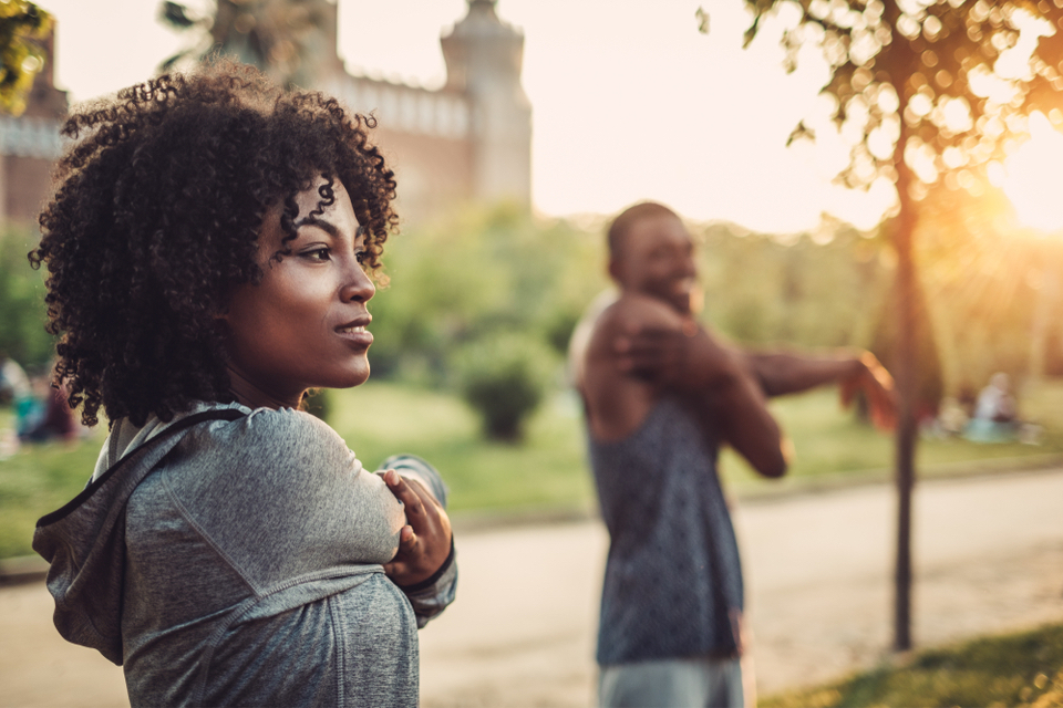 Man and woman stretching outside