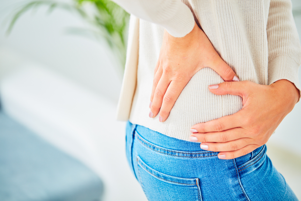 Close up of hands holding the side of the hip