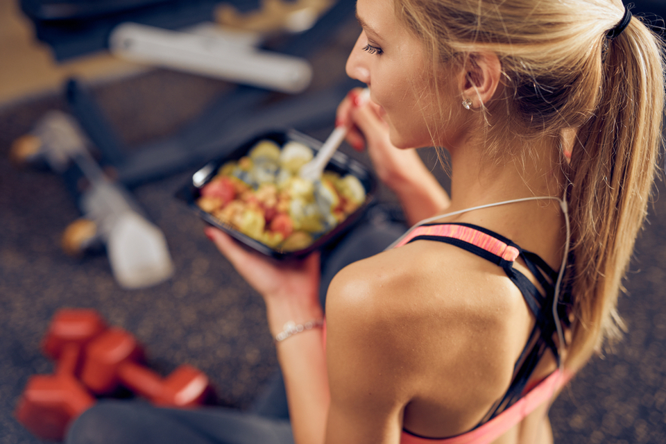 Woman eating food in the gym