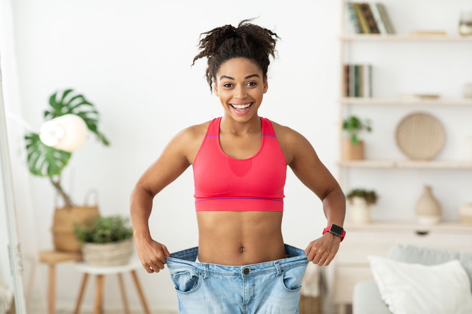 Smiling woman in oversized jeans