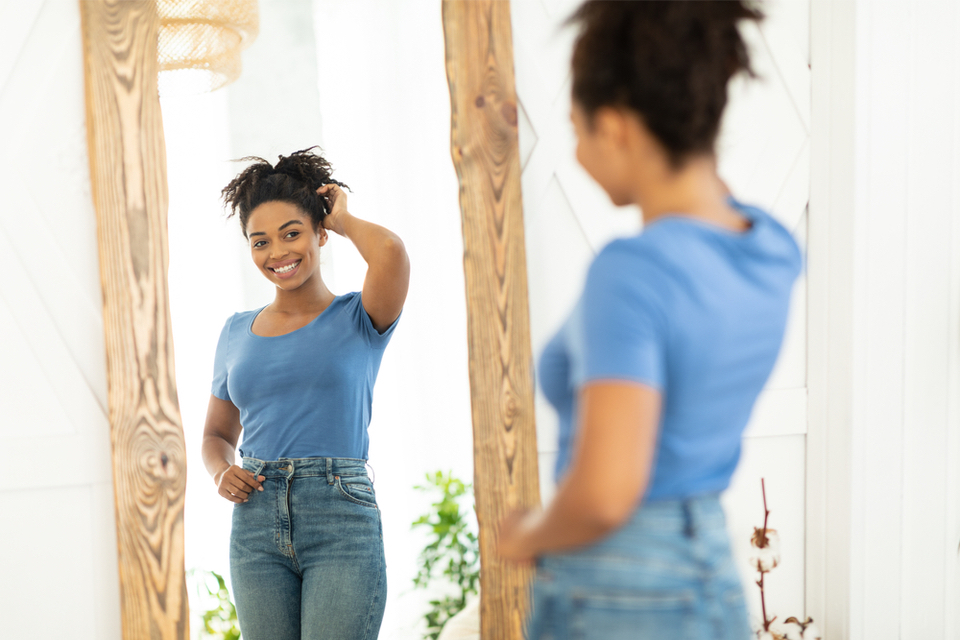 Woman smiling at herself in the mirror