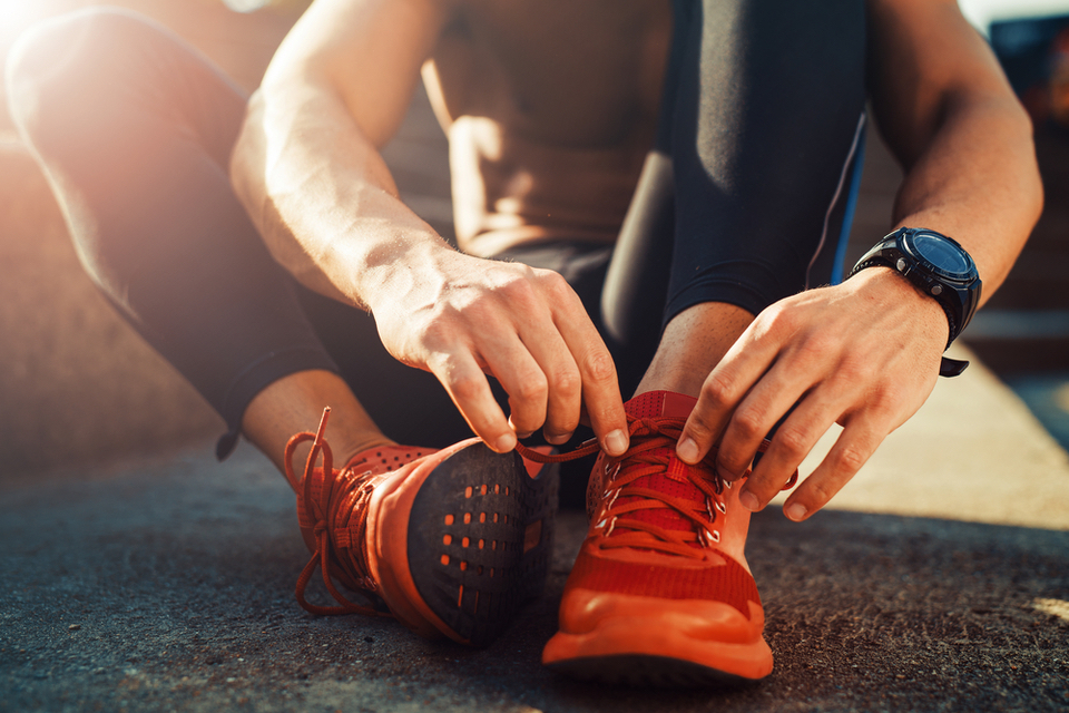 Close up of hands tying a shoe