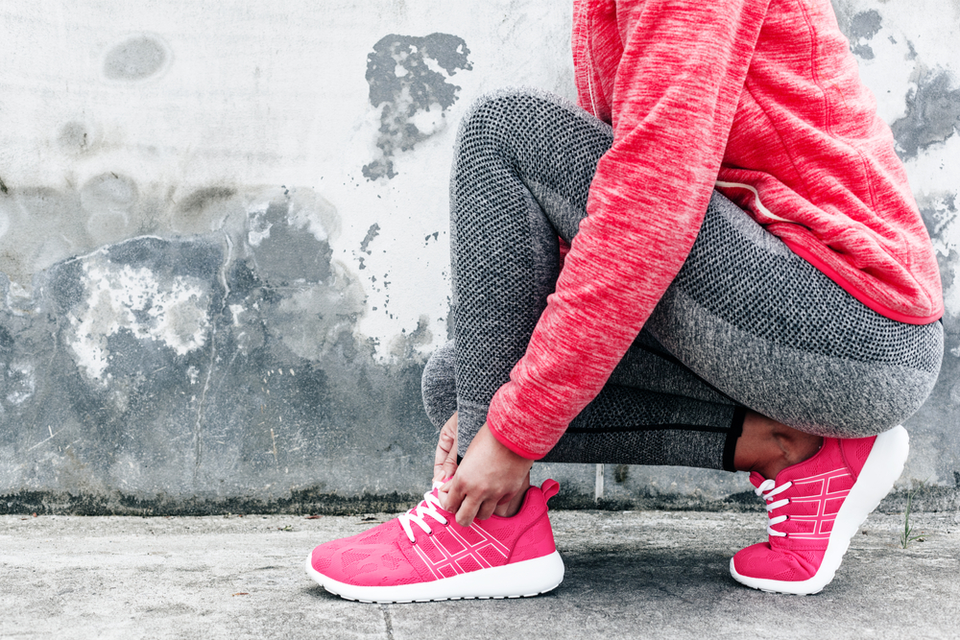 Woman tying her running shoes