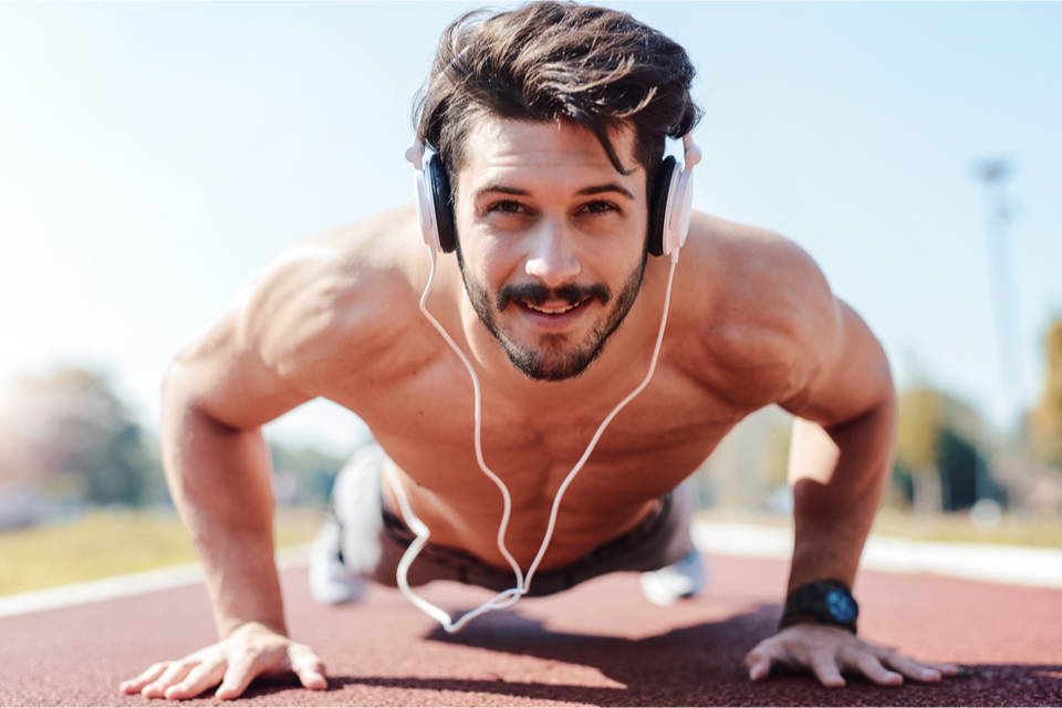 Man doing push ups on a track