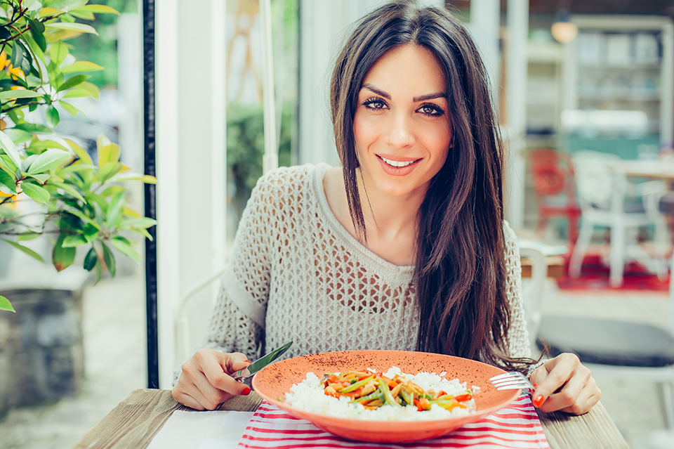 Woman smiling before eatinga bowl of food