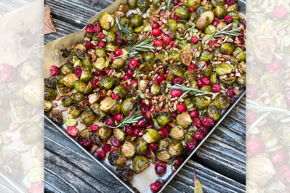 Pan full of brussels sprouts , nuts and cranberries