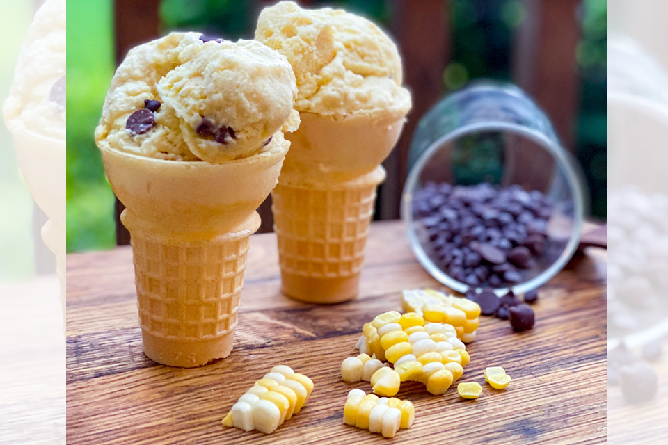 Ice Cream cones on a table with spilled corn and chocolate chips