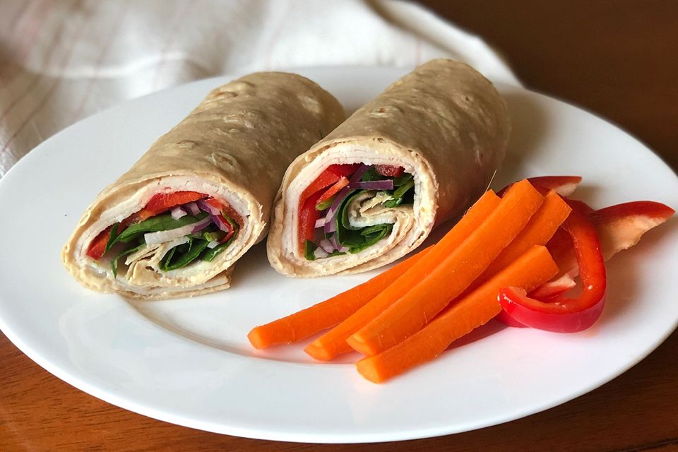 Turkey wrap with a side of sliced carrots