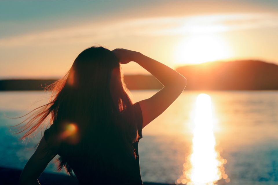 Woman staring at sunset