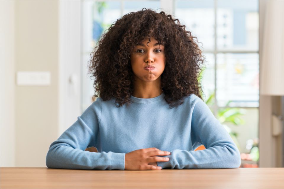 Woman puffing her cheeks out