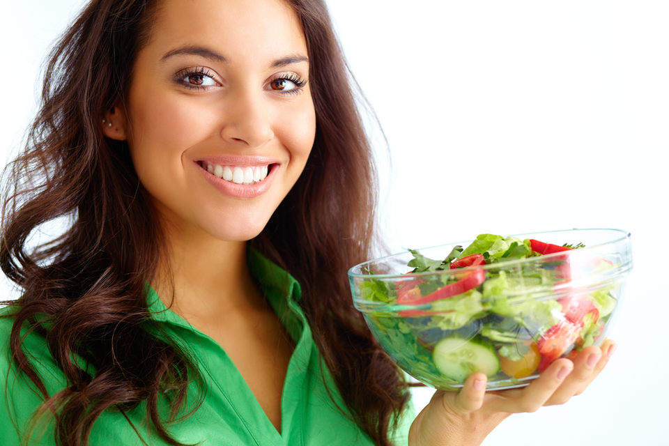 Smiling woman with a bowl of salad