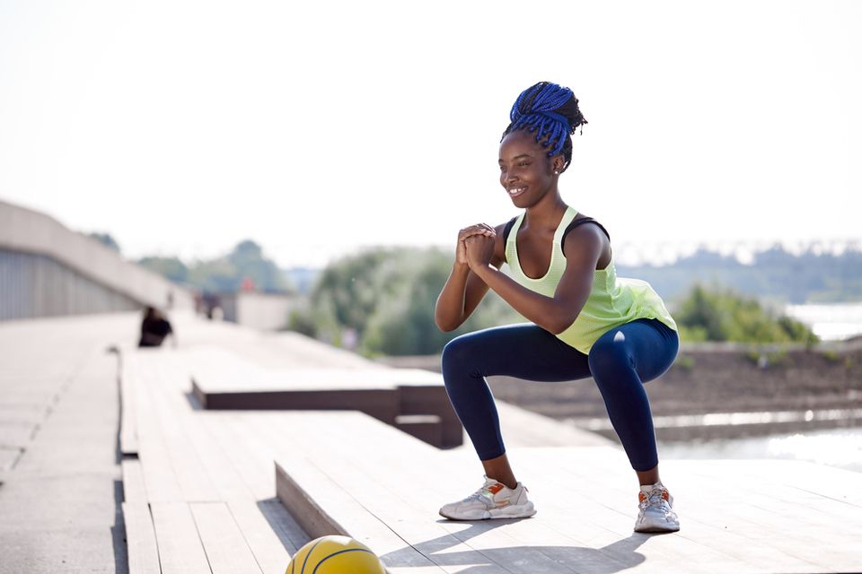 Woman doing squats outside