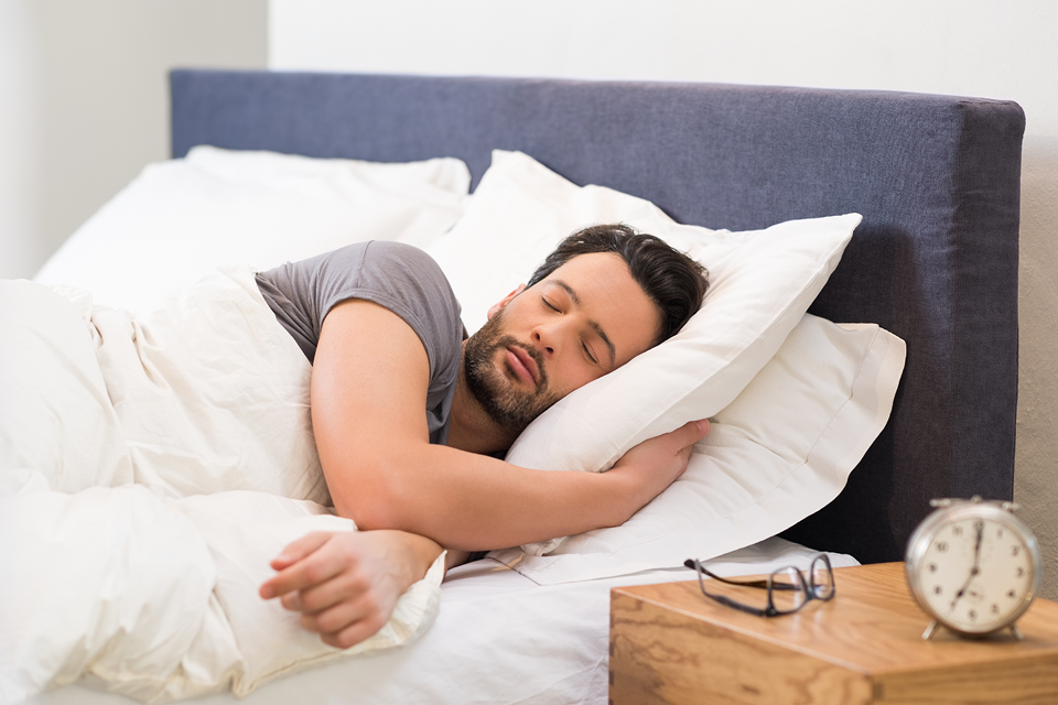 Man getting quality sleep in bed.