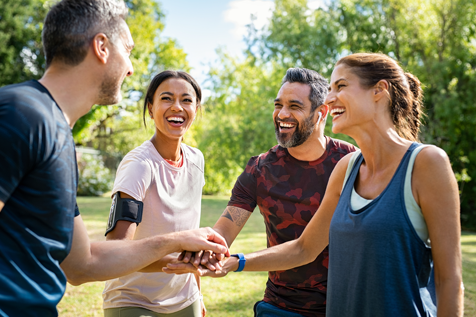 Social gathering of happy, active friends outdoors.