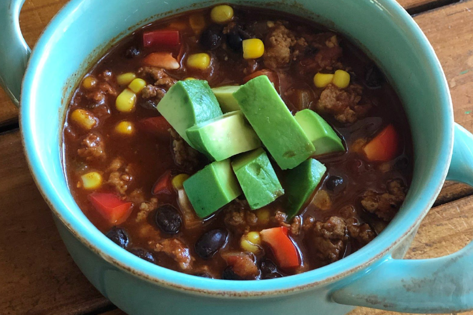 Bowl of Turkey Chili topped with avocado